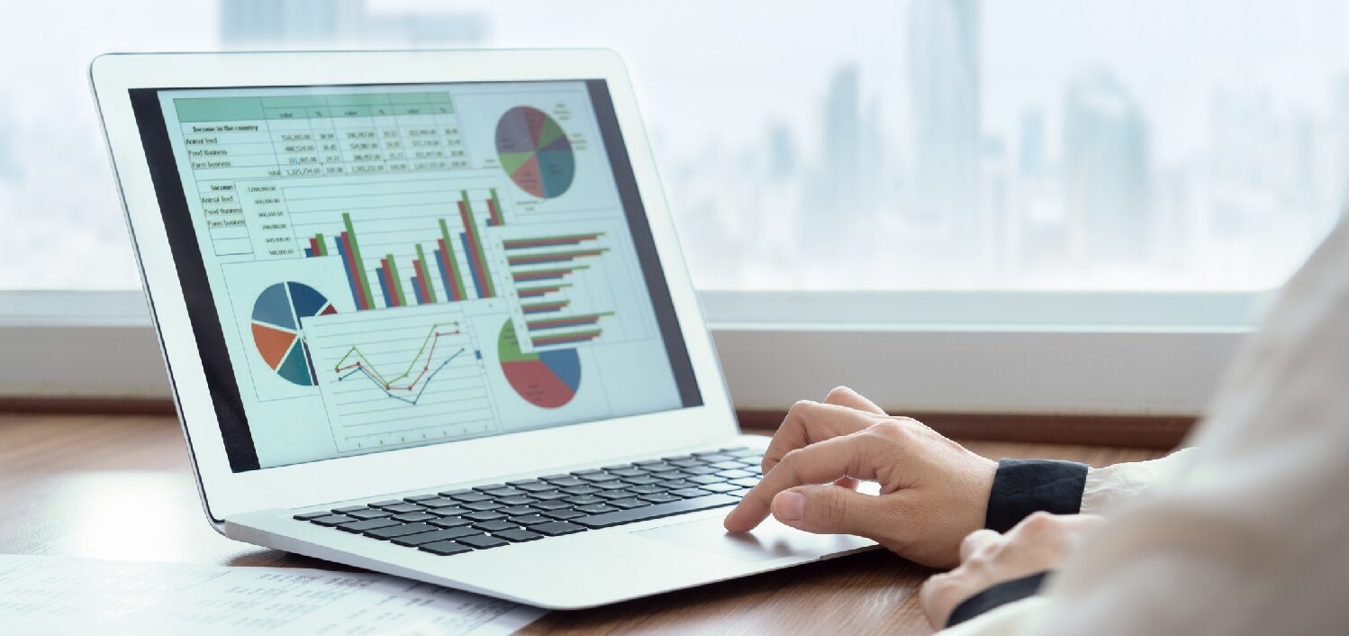 Accounting report spreadsheet. Business women using computer prepare business report for evaluation performance.